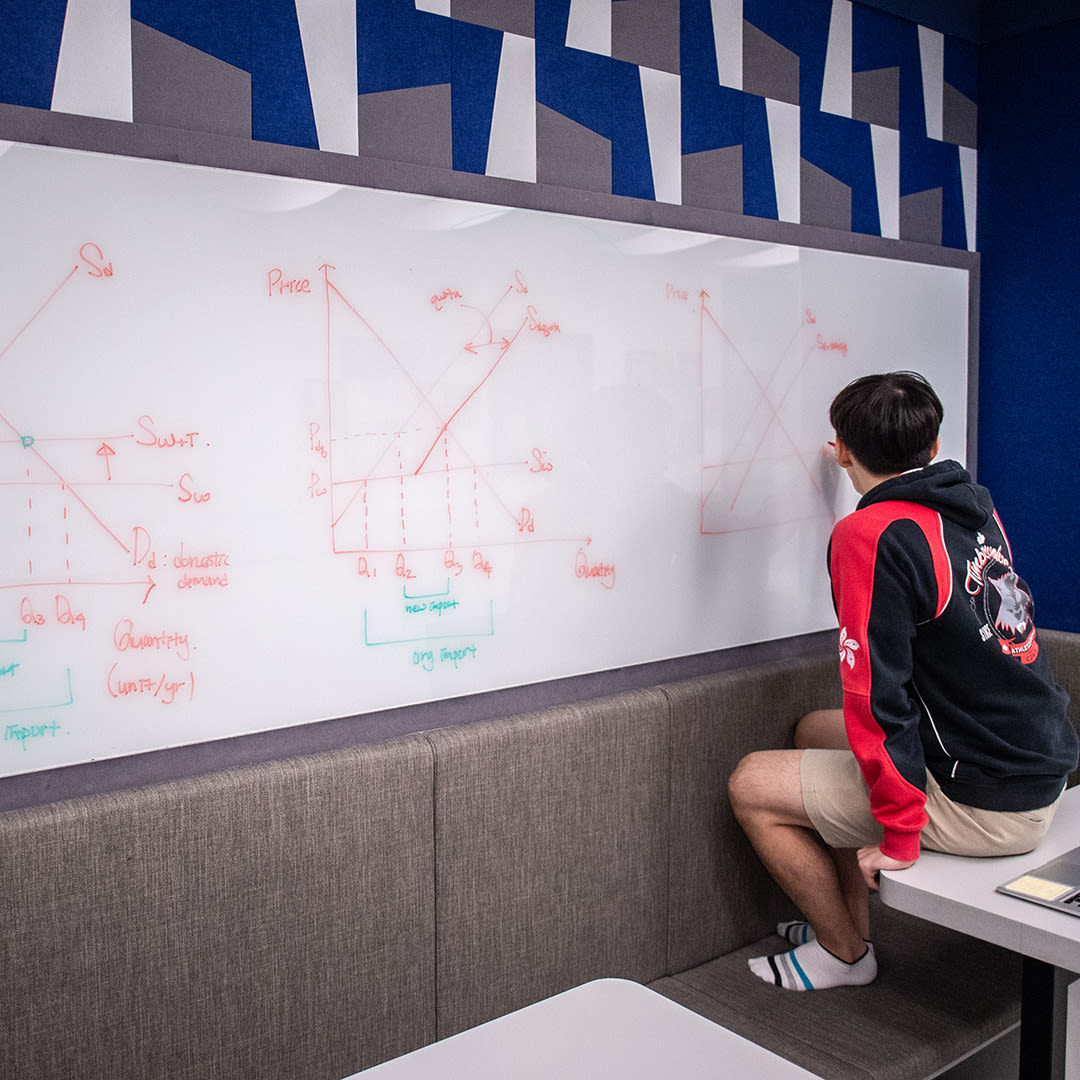 Upper School student writing on a whiteboard