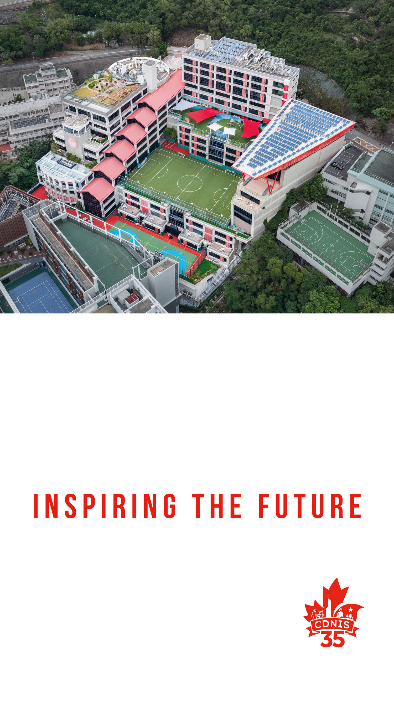 This aerial view showcases a large, multi-level sports complex surrounded by lush greenery, with the text %22INSPIRING THE FUTURE%22 prominently displayed.